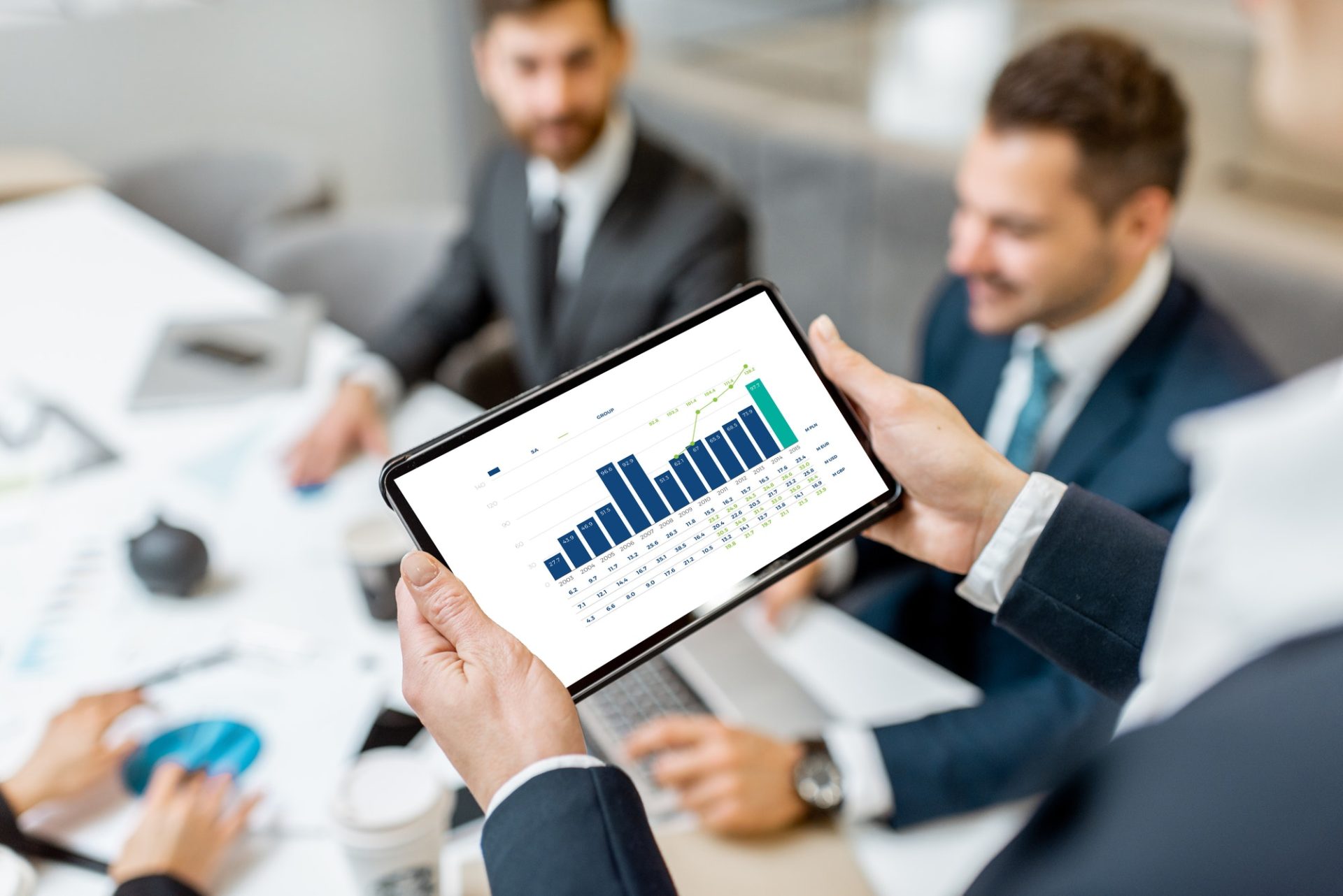 Financial conference, holding a tablet